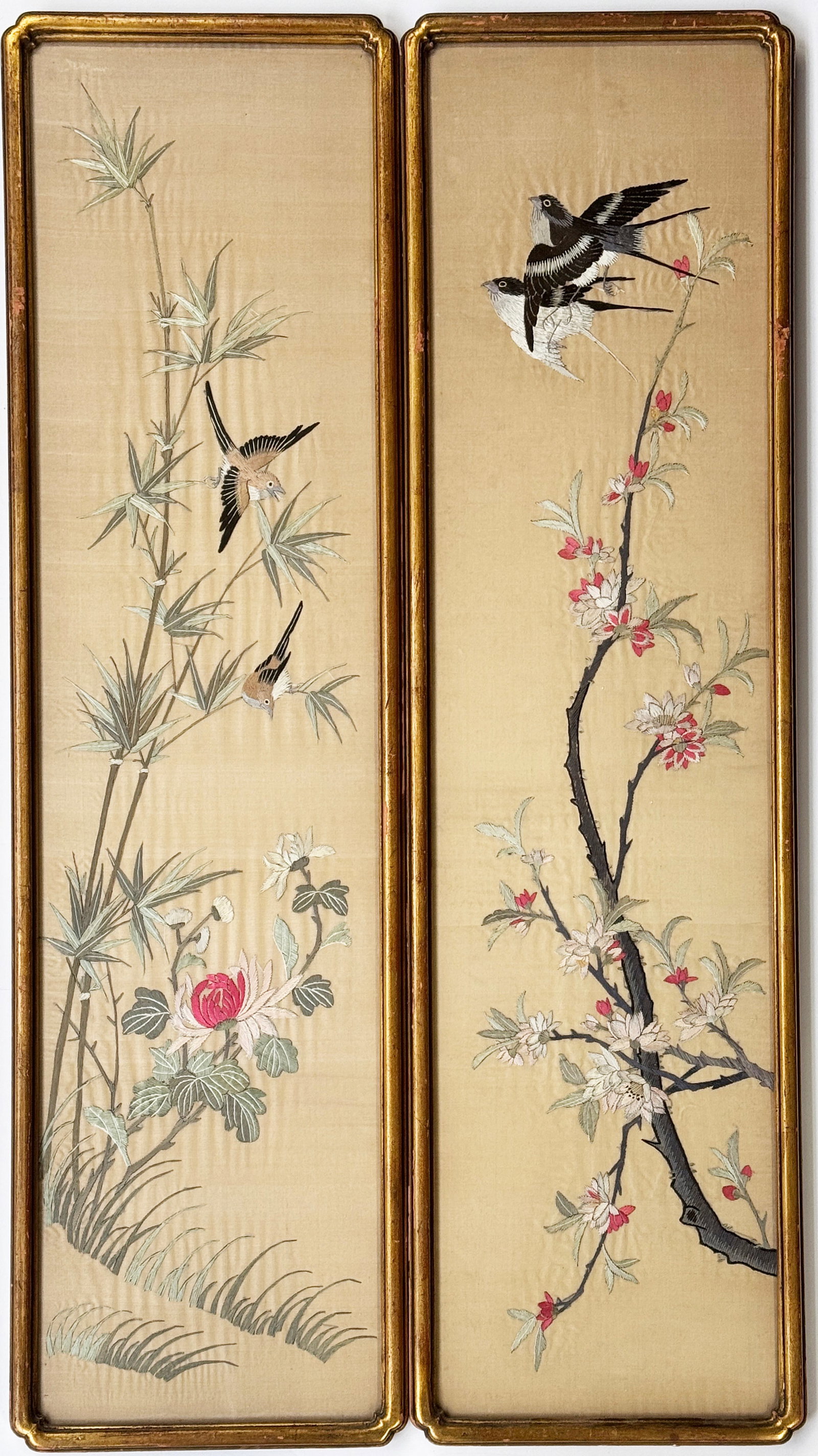 Pair of Chinese Silk Embroidery Pictures.: The pictures are of birds in flowering trees. They are in gilt frames. There is wear to the gilt frames, but the embroideries look to be in good overall condition. The frames measure 40 1/2" x 11". Th