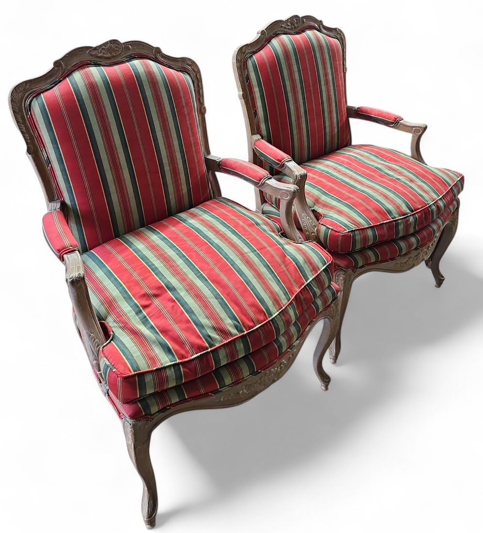 Pair of Louis XV Style Fauteuil Armchairs.: This pair of Louis XV style fauteuil armchairs have carved floral designs and silk striped upholstery. The seat cushions are removable. Each chair measures 38 1/2" tall, 26" wide, and 20" deep. There 