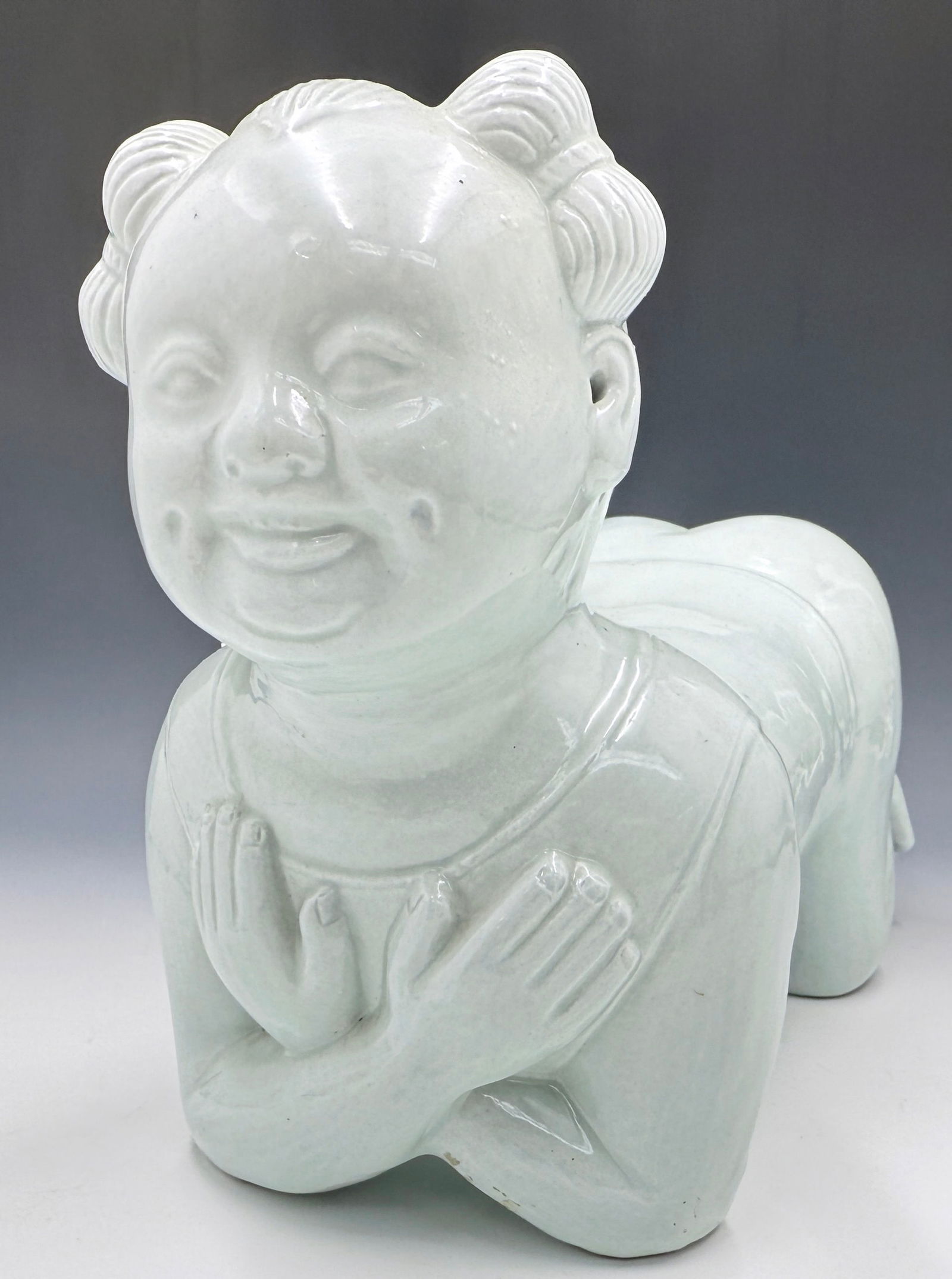 Chinese Porcelain Baby Shaped Pillow.: This light grey figure is in good overall condition. It measures 9 3/4" tall, 13 3/4" from front to back, and 5 3/4" wide. In-house shipping is available. Please see our website regarding in-house shi