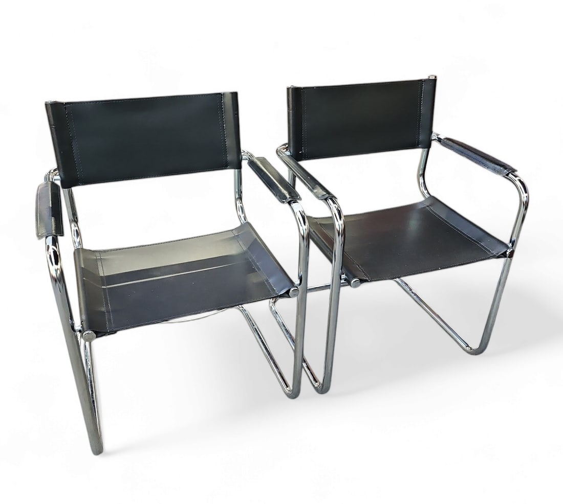 Pair of Stam Style Leather Armchairs.: These Stam style chairs are manufactured in Italy. They have chrome tubular frames and black leather seats, backs, and armrests. There are some scratches and wear marks on the leather, but overall, th
