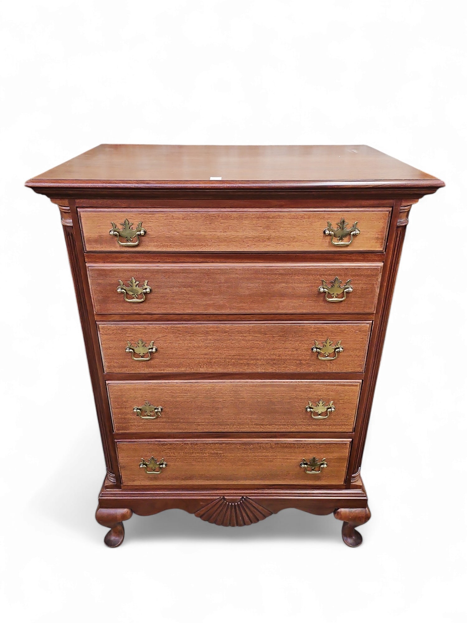 Mahogany Chest.: This five-drawer chest is manufactured by Heirloom Furniture. It features column style sides, fan carvings, carved legs, and floral brass handles. There are some scratches, and the veneer on one drawe