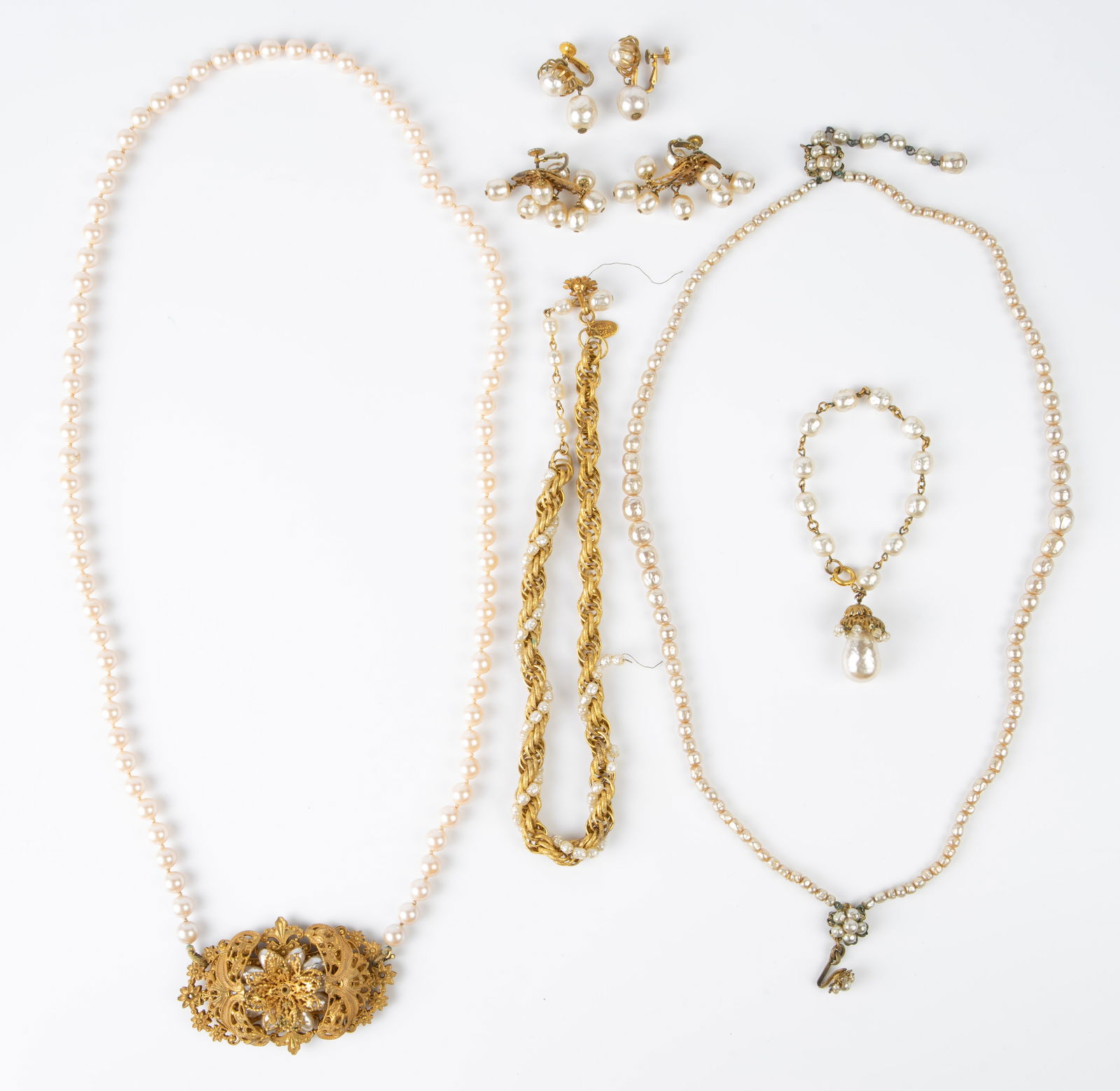 6 Pcs. Miriam Haskell Faux Pearl Jewelry.: The lot contains 3 necklaces, a bracelet and a pair of earrings. The necklace with the large clasp (measures 3" x 1 7/8") and the bracelet are not signed. The rest of the pieces are all signed. The lo