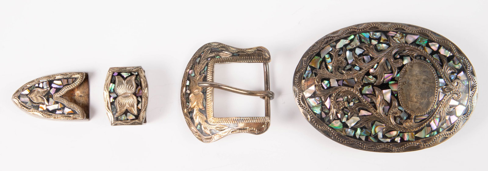 4 Mexican Sterling & Mother of Pearl Belt Pieces.: The lot includes 4 pieces in total, two of which are buckles. First, there is a large oval buckle which measures 3 1/2" x 2 1/2". Next, there is a set of three pieces, which includes a buckle, a belt 