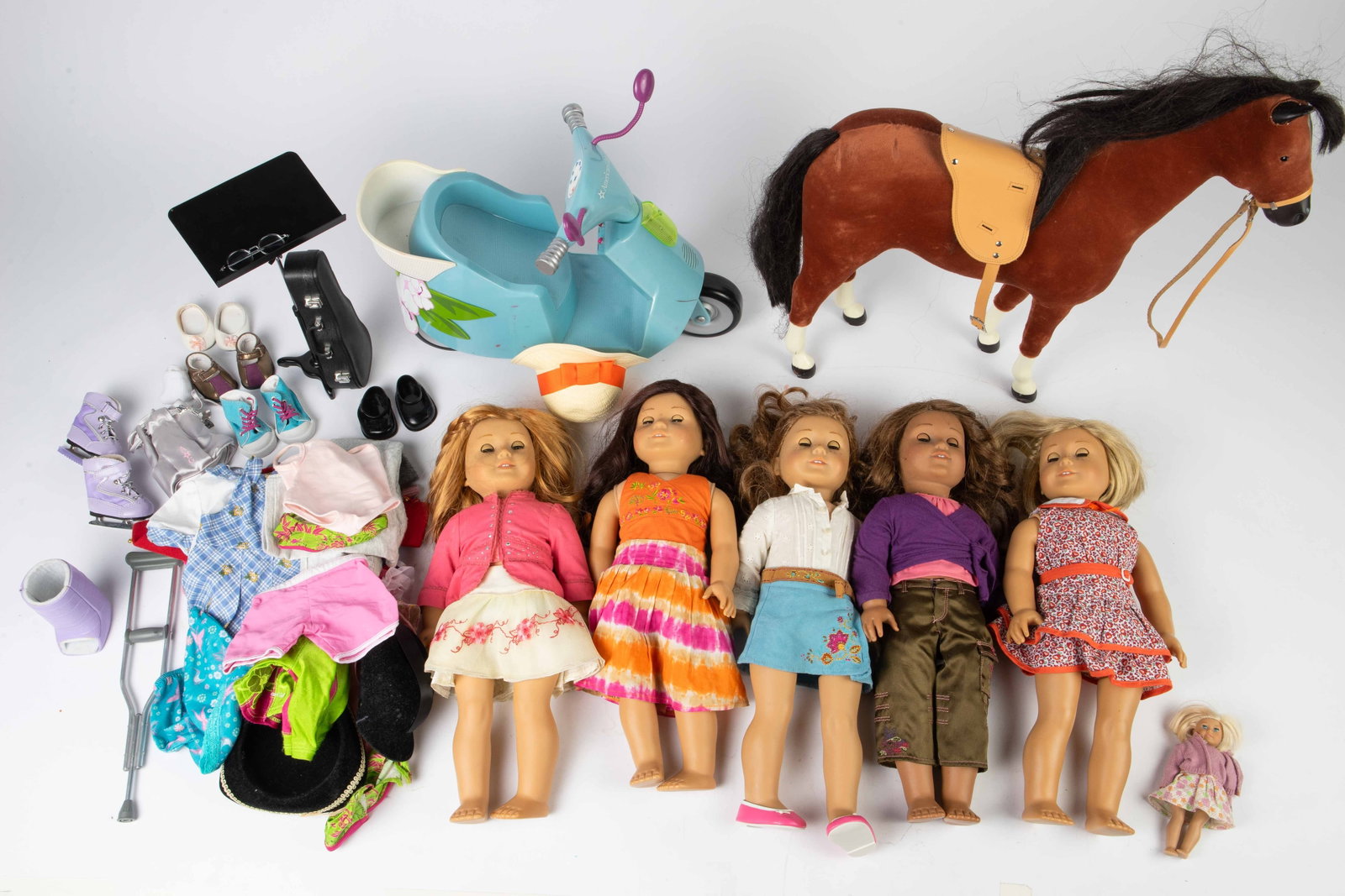Lot: 5 American Girl Dolls w/ Accessories.: This lot includes Kit Kittredge, as well as several of her outfits. The other four dolls are Marisol, Nikki, Mia, and Jess. There are hats, clothes, and other accessories included. The larger accessor
