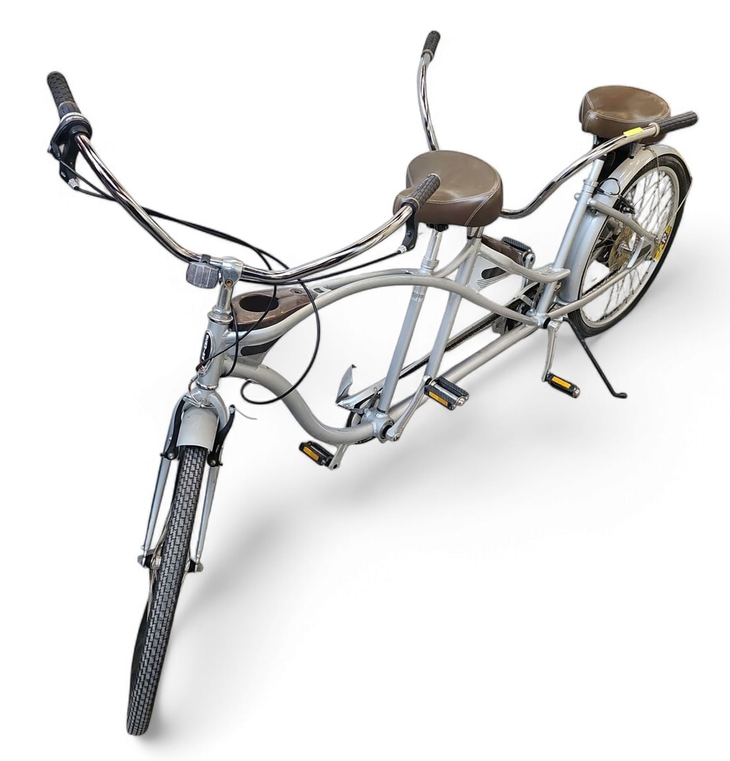 Schwinn Tango Silver Tandem Cruiser Bike: This vintage tandem bike has 25" wheels and brown leather seats. The bike measures 100" long. There are some scuffs and stains on the bike. Otherwise, it appears to be in overall good condition. Third