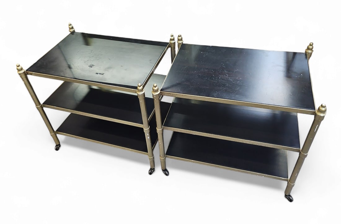 Pair of Mark David 3 Tier Side Tables.: This pair of side tables on casters has the Mark David plaque on the underside of the top. They have dark wood surfaces, and metal hardware with brass colored finish. The tables measure 24" tall, 26" 