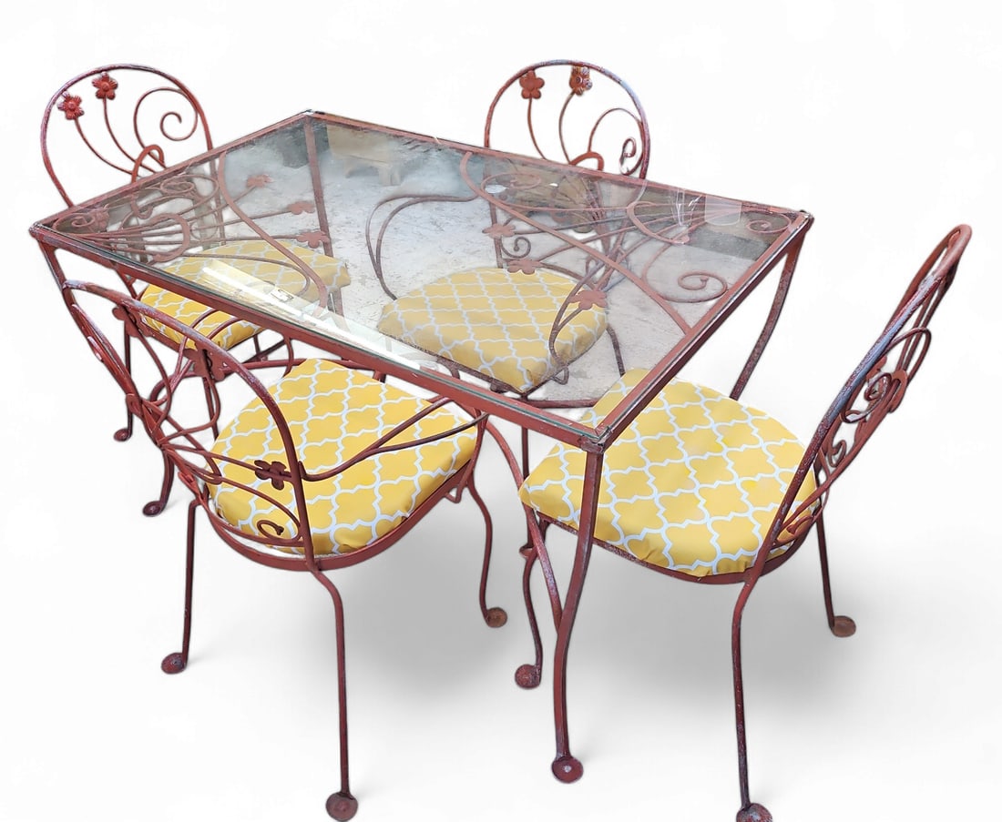 Wrought Iron Glass Top Patio Set w/ 4 Chairs.: This patio or garden set is painted a deep terracotta color. There are 4 chairs - 2 with arms, and 2 without. The chairs have removable seat cushions with yellow modern upholstery. The table measures 