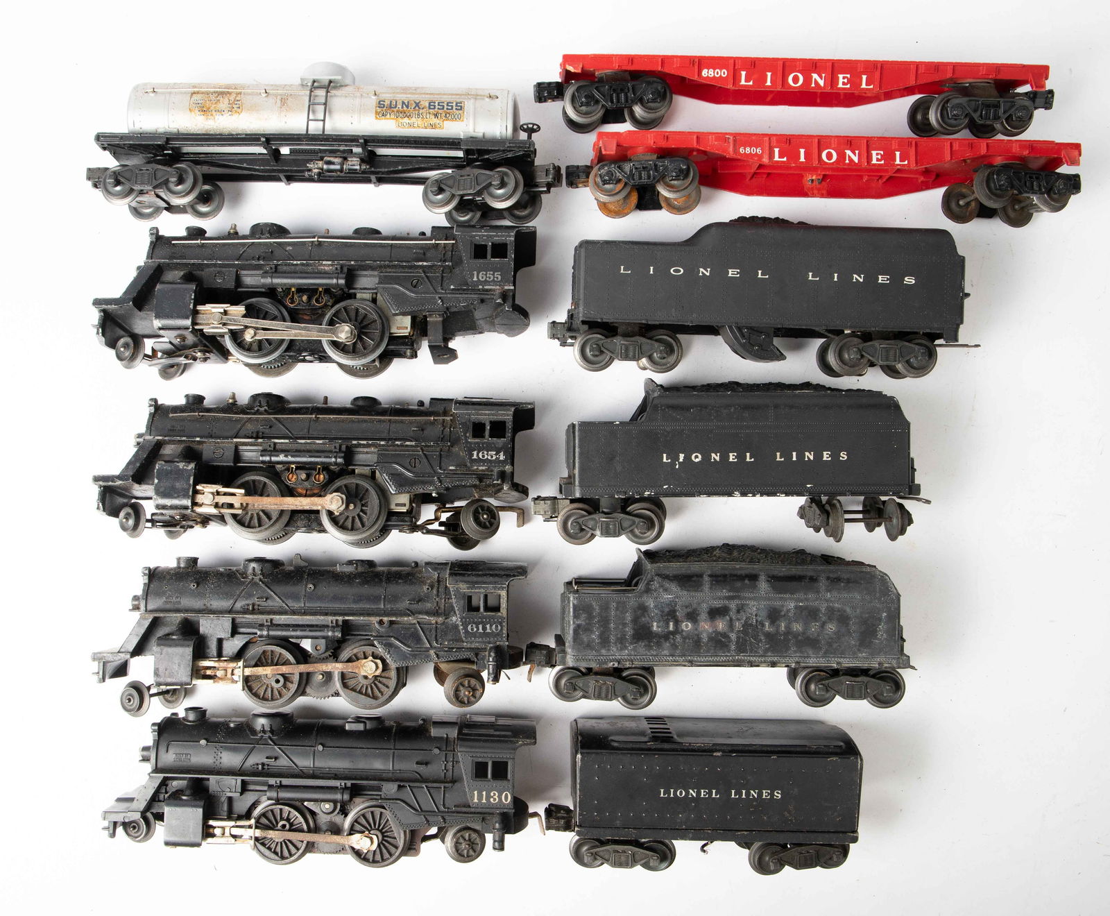 Lot of Lionel Locomotives and Other Cars.: This lot includes four 2-4-2 locomotives (1130, 6110, 1654, 1655), four tenders, two 6806 flat cars, and a SUNX 6555 tank car. The 1655 locomotive is missing its trailing wheels. Nothing has been test