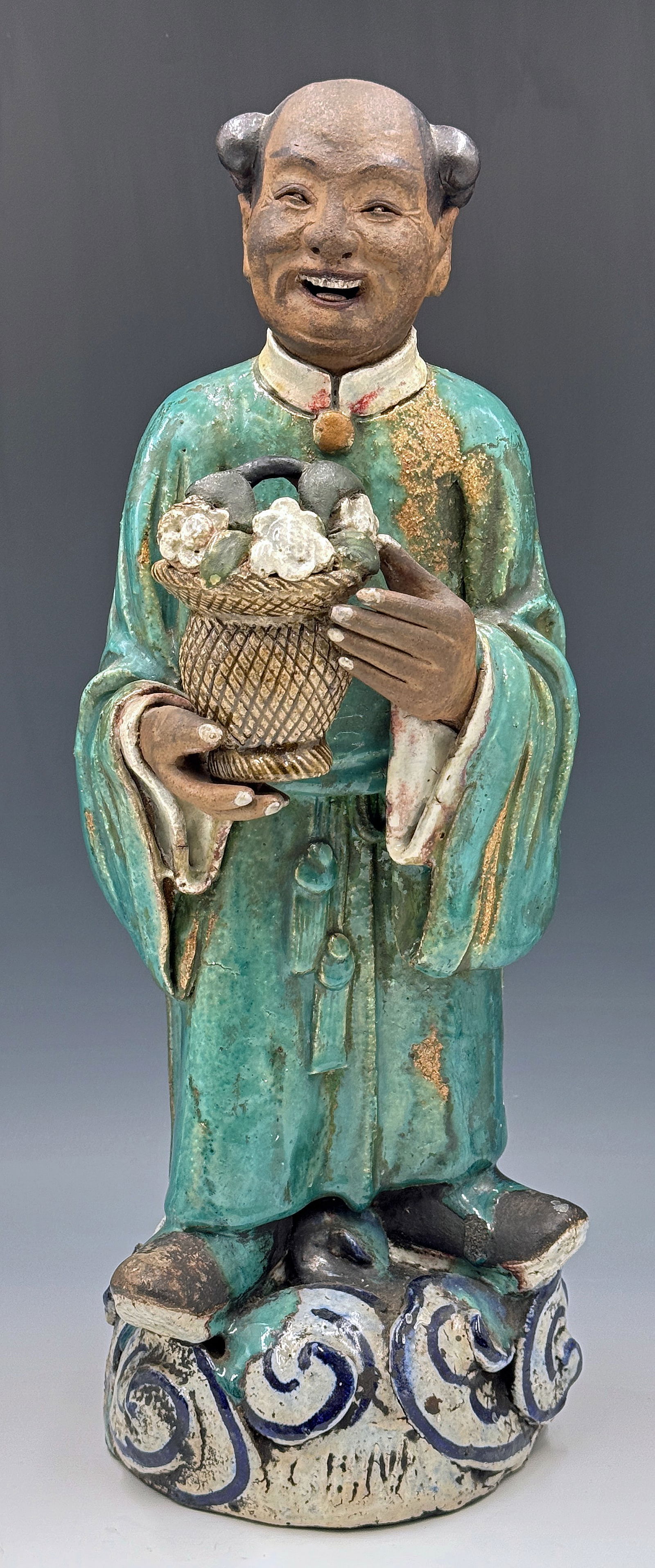 Old Chinese Majolica Immortal Figure w/ Flowers.: The figure has a bit of glaze loss, but is in otherwise good overall condition, with some wear to use. It has a manufacturing defect on his robe. The figure stands 16 1/4" tall and 5 1/2" wide. In-hou