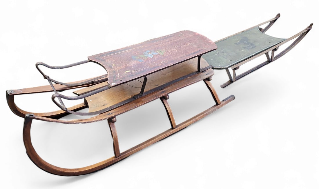 Lot of Three Antique Wood Sleds.: One of the sleds is painted red with flowers, while another is painted green with a star and a horse. The bottom of the green sled reads, "W.H. - 1909." The sleds are worn, and the metal rails have ru