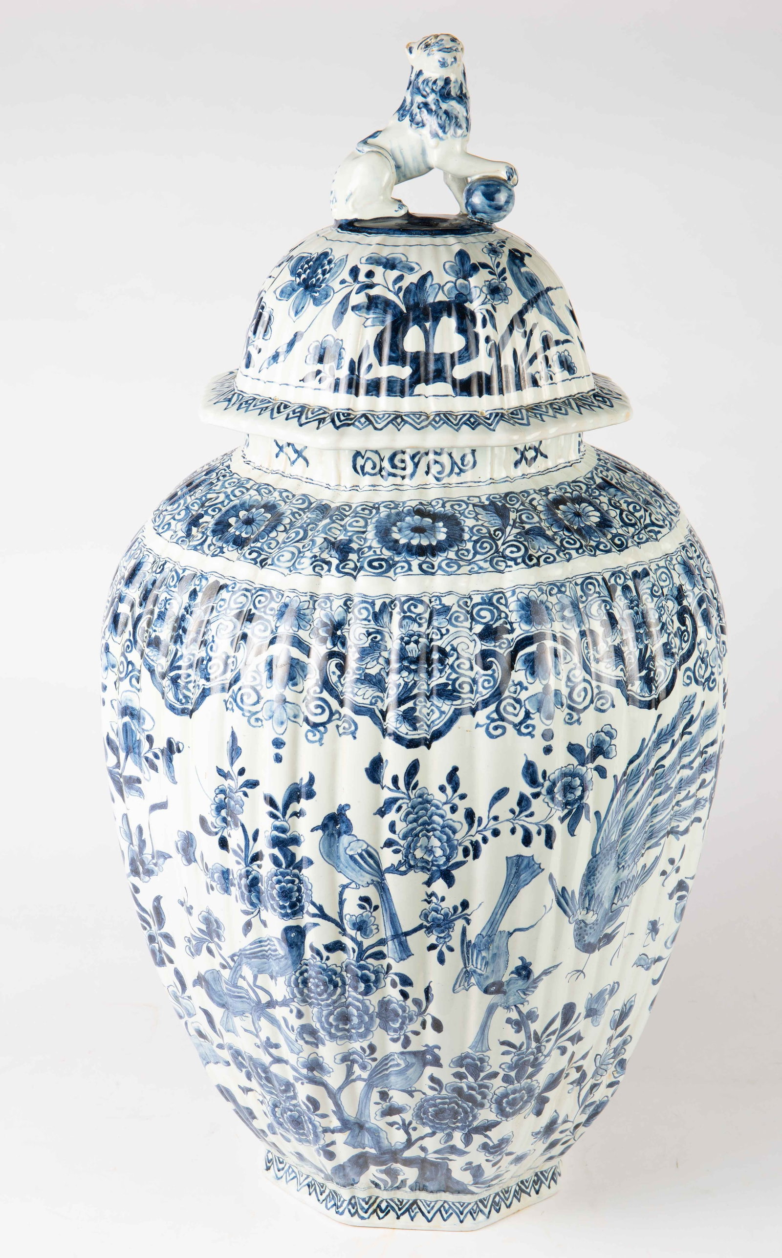 28" Gerrit Pietersz Kam Covered Chinoiserie Jar.: This large blue and white Chinese style earthenware jar is decorated with flowers, birds, and a lion finial. The underside of the jar is signed, "GK", possibly for Gerrit Pietersz Kam of the Drie Post