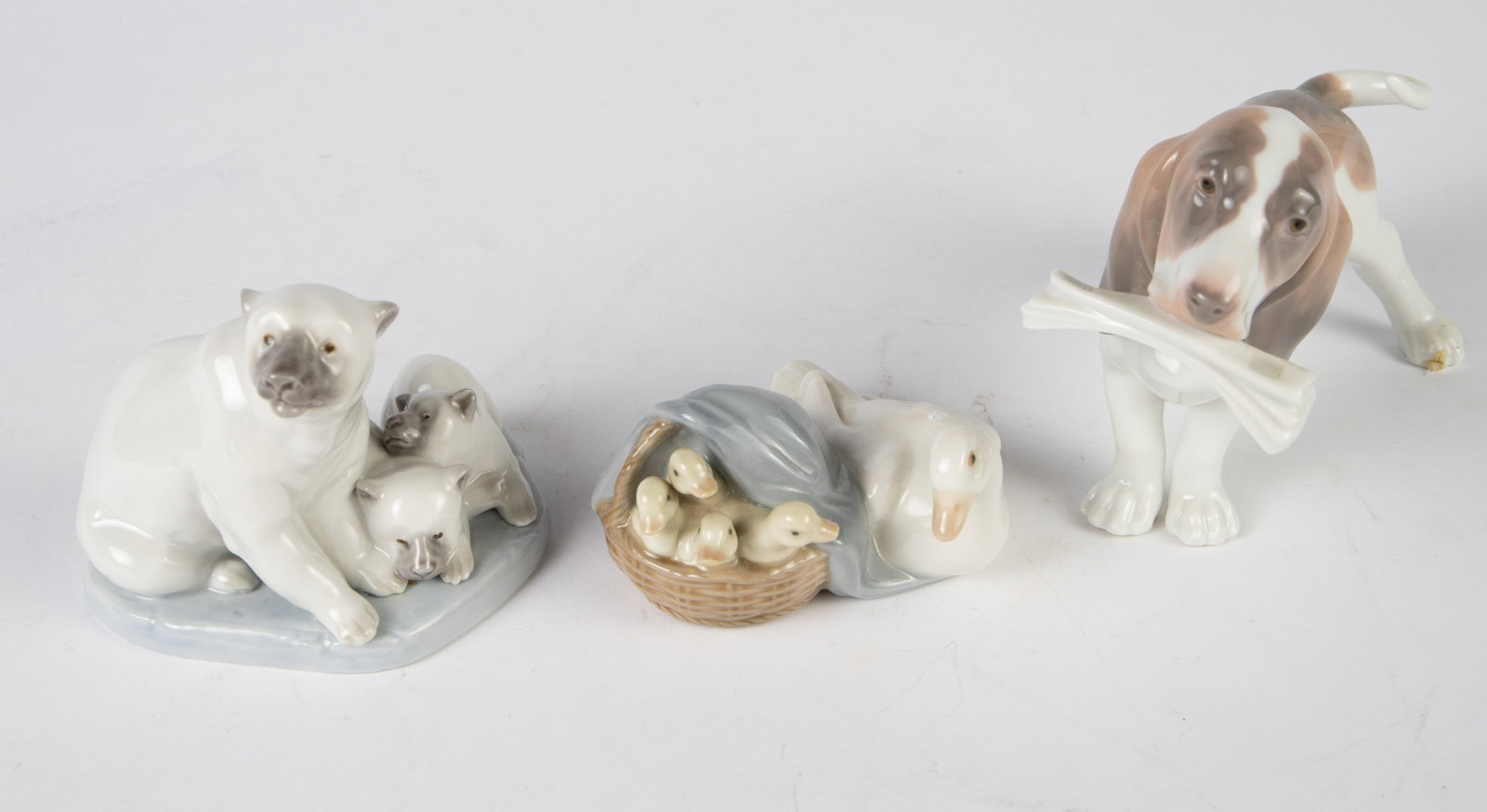 Lot of 3 Lladro Animal Figurines.: They are a basset hound, a duck with ducklings, and a polar bear with cubs. Overall, the lot looks to be in good condition. The hound dog could use a light cleaning. It is the largest figure, measurin