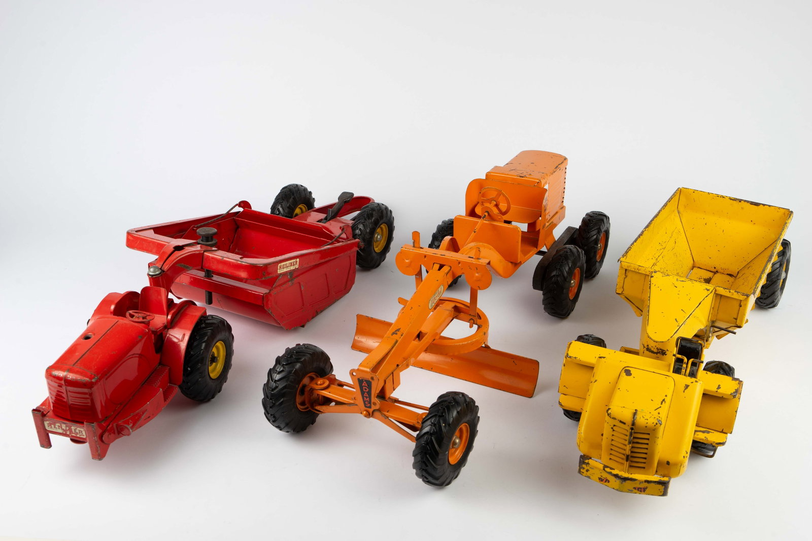 3 Large Die Cast Toy Tractors - Doepke Model Toys: The lot consists of 3 vintage die cast or pressed steel toy tractors in 1:12 scale, circa 1940. There are two pieces by Doepke Model Toys: a die cast Adams Motor Road Grader, and a pressed steel Woold
