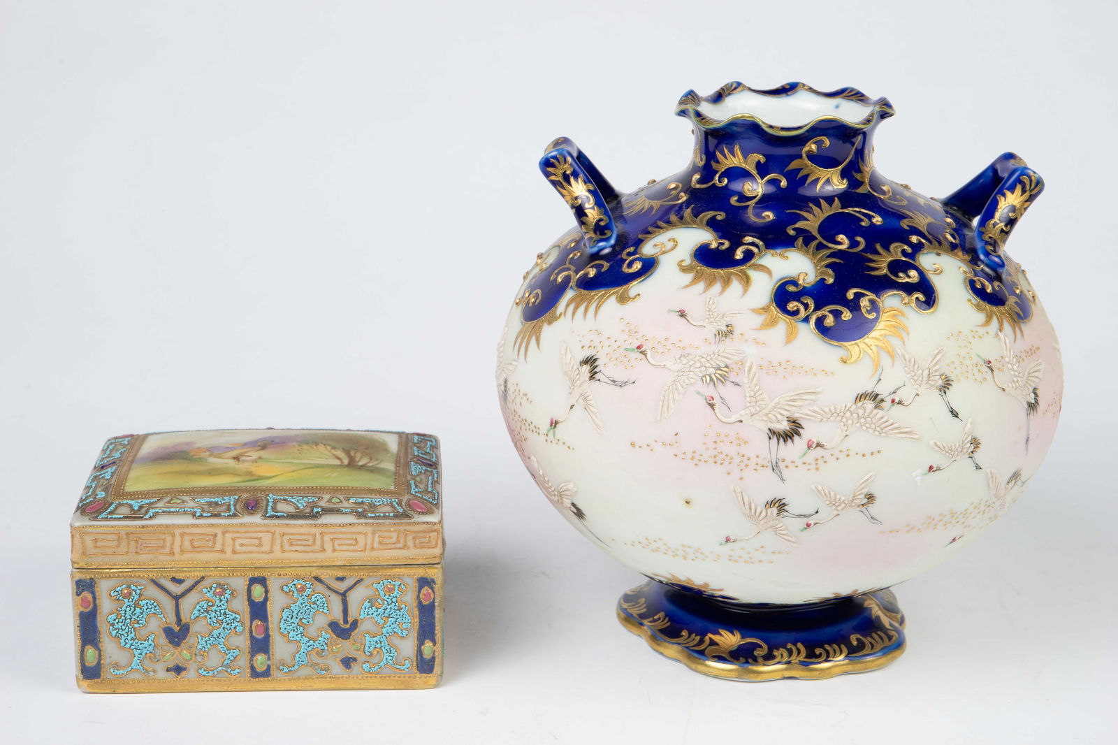 Lot: 2 Nippon Items- Trinket Box & Crane Vase.: The trinket box is by Morimura Brothers. It has been repaired along one of the sides. The vase with flying cranes looks to be unsigned. Overall, it looks to be in good condition, with some minor scrat
