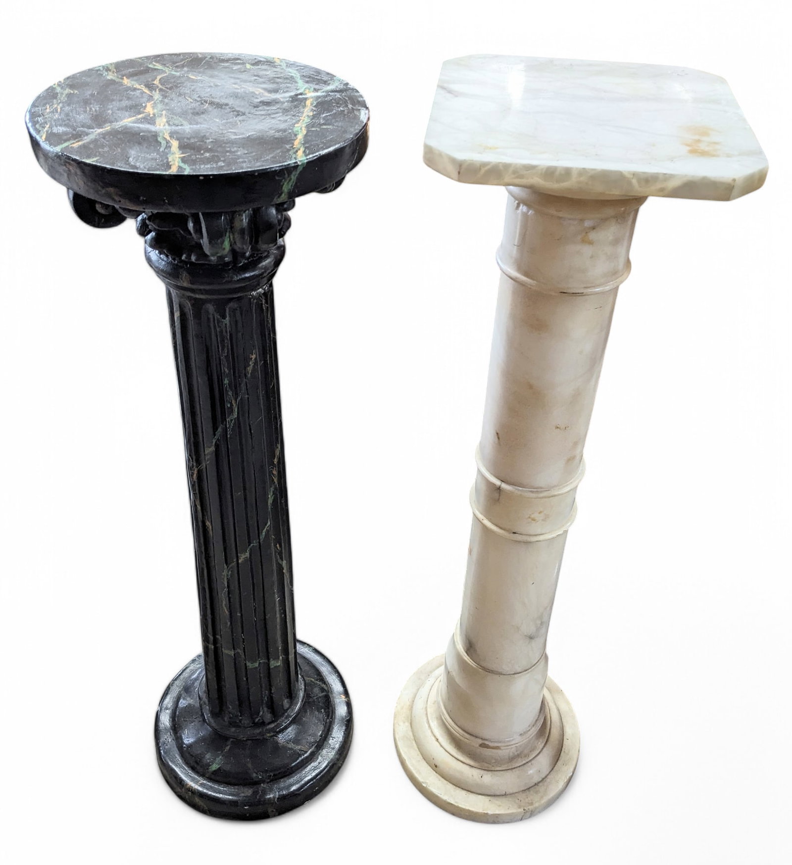 Two Pedestal Stands - One Made of Marble.: The white stand is marble, while the black stand is painted cement. They are both in good condition, with minor scratches and scuffs. The marble stand measures 40" tall, with an 11" x 11" top. The cem