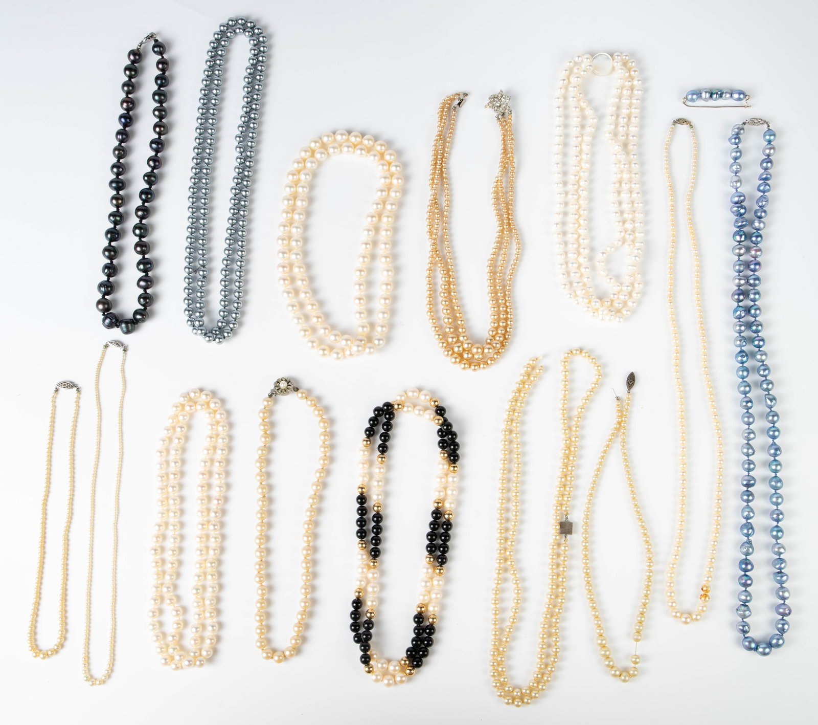 Lot of Mostly Vintage Pearl Necklaces - 14K, 925.: The lot contains 14 necklaces and 1 brooch. At least 5 of the necklaces are made with natural pearls. A few of them are graduated. A few of the clasps are 14K white gold, 10K, or sterling silver. A do