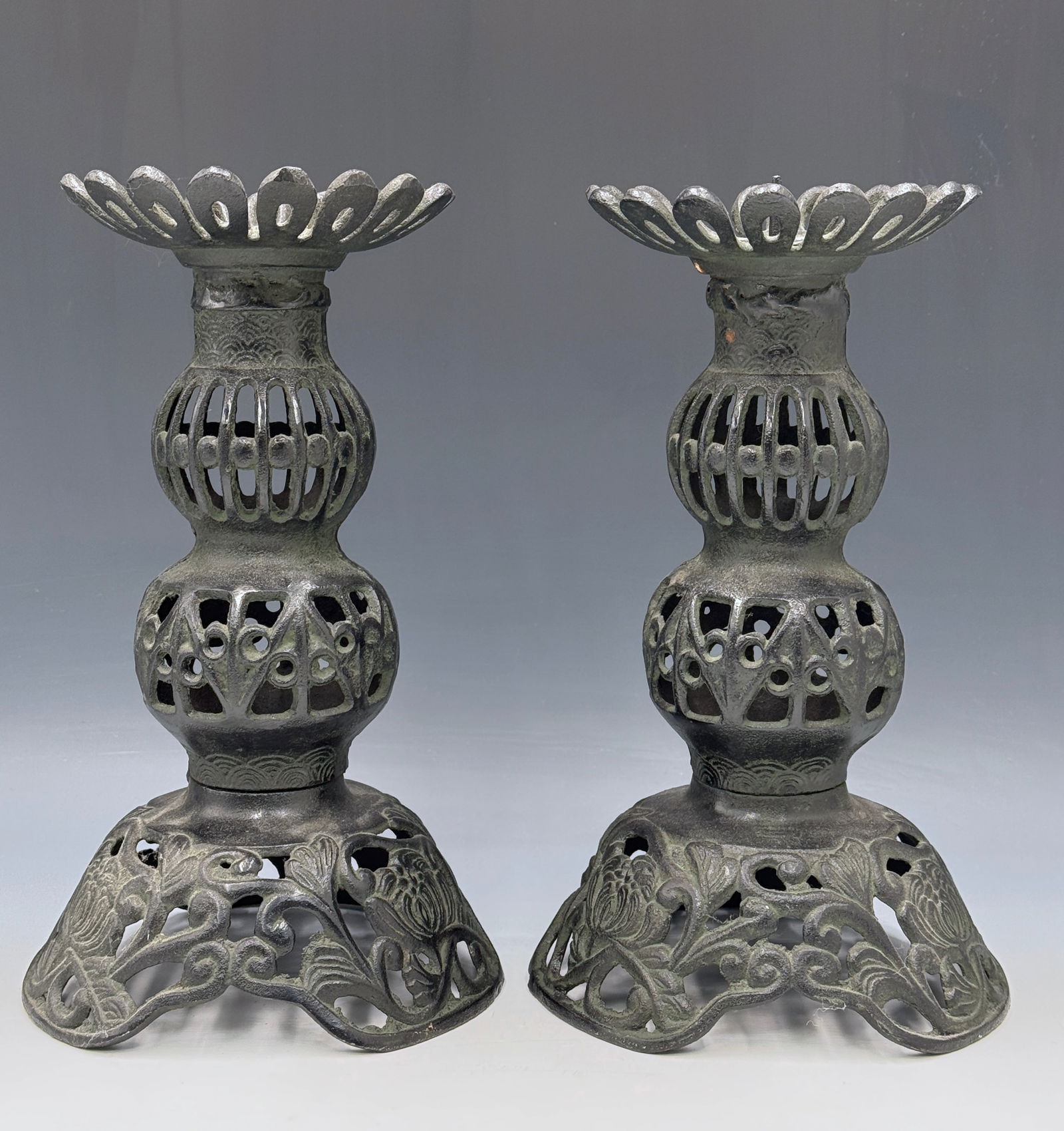 Pair of Vintage Japanese Cast Iron Candleholders.: One of them is missing its insertable candle spike. Other than that, they look to be in good overall condition. Each candlestick measures 10 1/4" tall and 6" in diameter at the base. In-house shipping