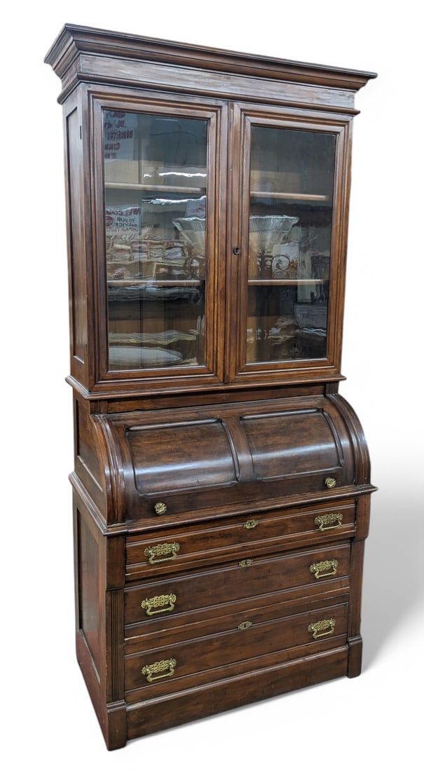 Victorian Cylinder Roll Top Secretary w/ Bookcase.: This antique secretary desk has cubbyholes and a drawer. Below the desk are three lockable drawers with brass hardware (a key is included). Above the desk is a bookcase with two adjustable wooden shel