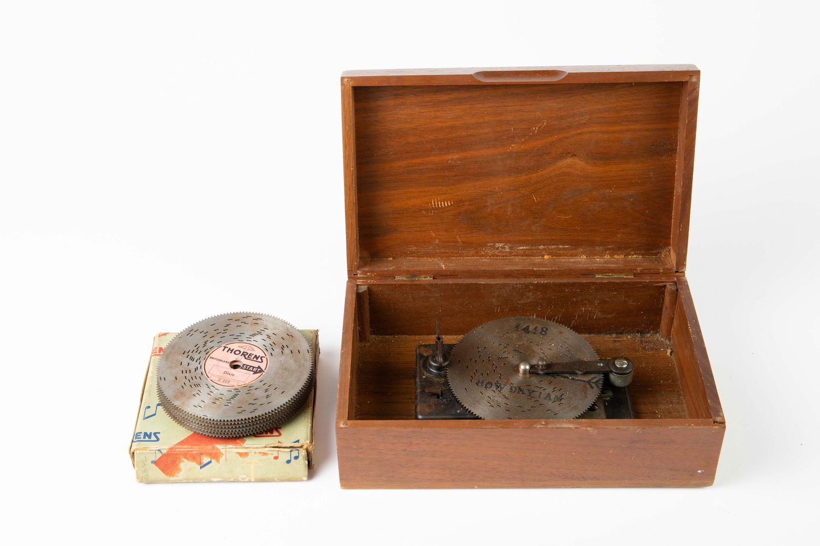 Lot of 17 Thorens Switzerland Music Box Discs.: A wood music box is also included, though its mechanism works a bit oddly. First of all, the stop lever never makes the music stop. Secondly, the disc will stop in the middle of a song, instead of at