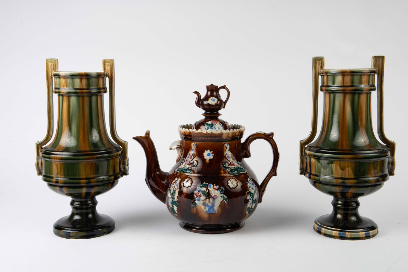 Lot: Bargeware Teapot, Pair of Pottery Vases.: The bargeware teapot has a teapot finial. It has some crazing, and there are some areas where the glaze is thicker and flaking. The footed urn vases have some deep crazing, more noticeable near the bo