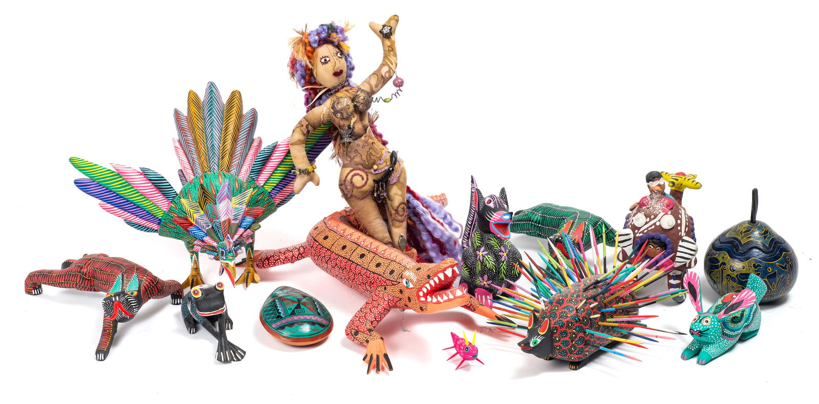 Lot: Mexican Folk Art - 8 Alebrije Figures & More.: The lot contains 8 signed carved wood alebrije figures, a hand carved and painted container, a whistling instrument, a ceramic sculpture, and an art plush doll. The alebrijes are signed Juan Sabian Cu