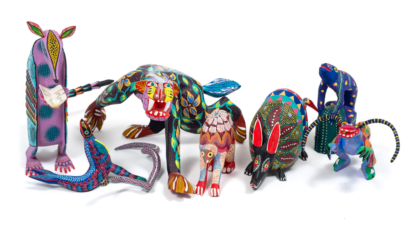 8 Mexican Carved Alebrije Figures - Some Signed.: The lot contains 8 carved wood folk art sculpture from Oaxaca, Mexico. Four of the smaller sculptures are signed. The signatures read Melecio Bic Oaxaca Mex., Marcelo Vidales F. SN Martin Tilcajete, B