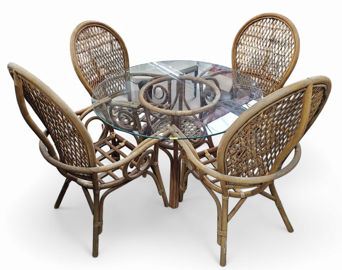 Rattan Glass Top Table and Four Chairs.: The set is comprised of a round glass top table, rattan base, and four matching rattan armchairs. There are some scratches and scuffs, but overall the pieces are in reasonably good used condition. The