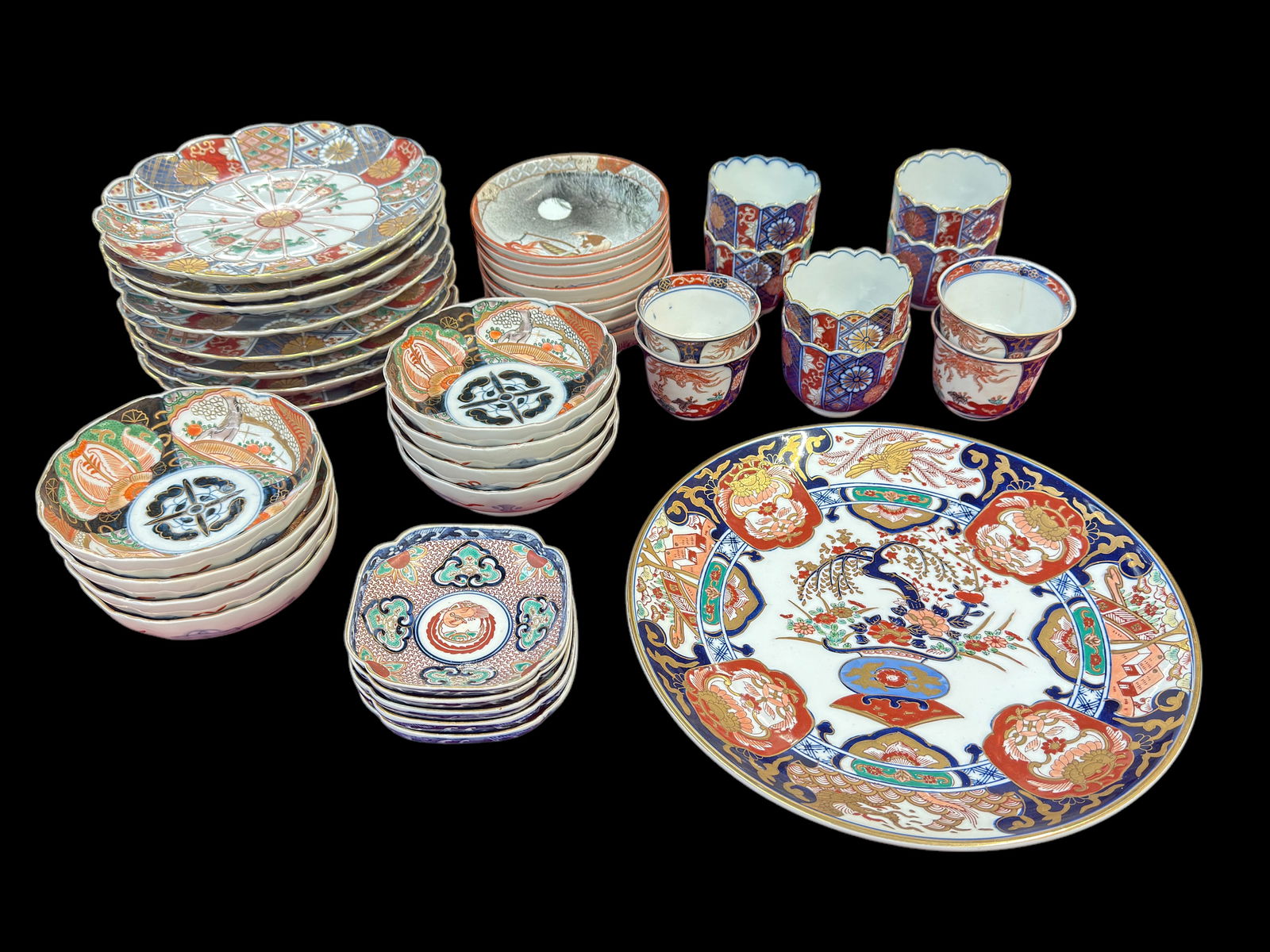 Lot: 40 Pcs. Assorted Japanese China - Imari, etc.: One of the older cups has a hairline crack. The other items look to be in good overall condition. Most of the items are old or at least vintage. The large plate is new. The lot includes cups, plates,