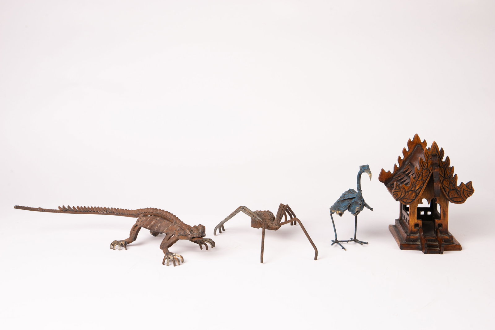 Mini Thai Spirit House & 3 Metal Animal Figures.: The lot contains 4 items in total. First, there is a miniature teak wood carved Thai Spirit House. It measures 6 3/4" tall, 4 3/4" wide, and 6 1/4" deep. The detail on the center front and back is a b