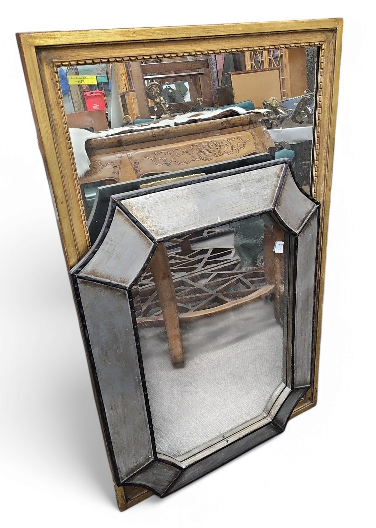 Lot of Two Wall Mirrors.: The lot includes a tall gold frame wall mirror which measures 26" wide by 42" tall. There is also a silver and black frame wall mirror manufactured by the Uttermost Company. It measures 24" wide by 32
