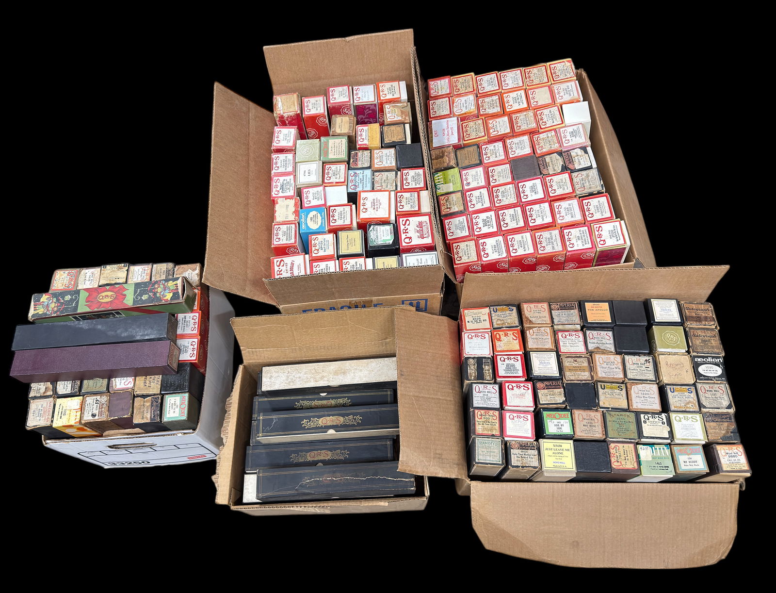 Lot of Piano Rolls - Q.R.S., Imperial, Melodee.: The lot includes over 140 Piano Rolls, and 18 empty Q.R.S. boxes. The lot includes music rolls and word rolls mostly from Q.R.S. - Other brands observed are Imperial, Aeolian, American, Rothschild Com
