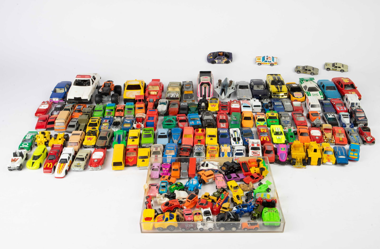 Lot of Vintage Toy Cars - Mostly Hot Wheels.: The lot contains over 150 toy cars. The earliest date observed is 1964, and the latest date is 1997. There are police cars, race cars, trucks, tractors, and more. Most of the cars are Hot Wheels. A fe