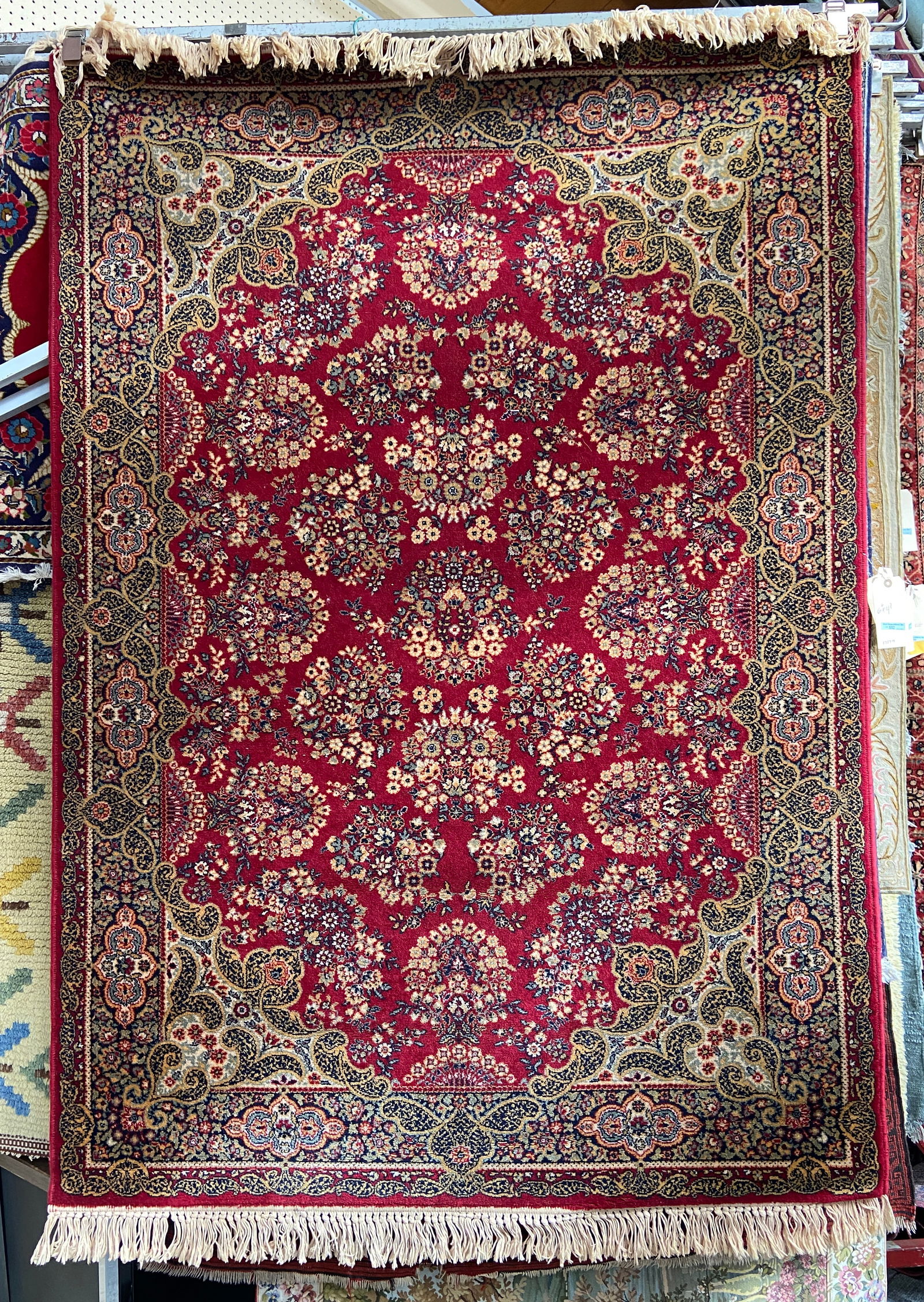 4' 7" x 6' 6" Red Machine Made Rug. (1 of 2)