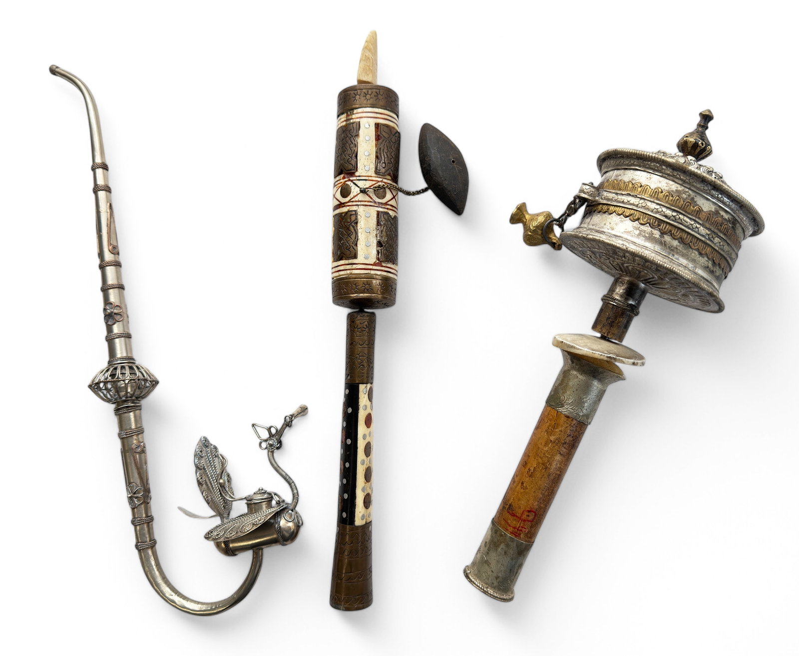 Lot: 2 Tibetan Prayer Wheels, Figural Opium Pipe.: One of the prayer wheels is brass and bone, and appears to be empty inside. The other wheel is wood and a silver tone metal, with a written scroll inside. The opium pipe 's bowl is shaped like a bird,
