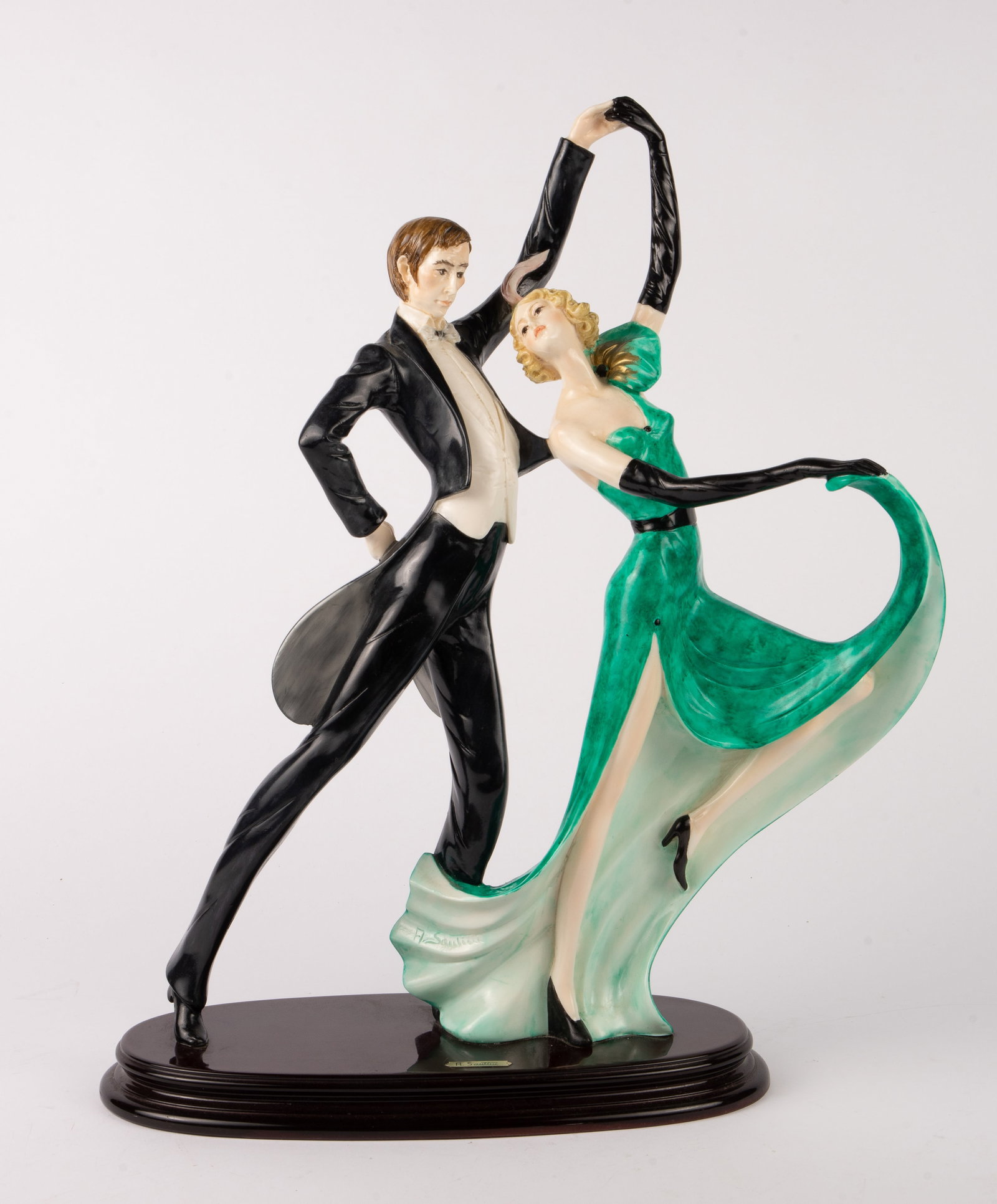 A. Santini 21" Figural Group of Dancing Couple.: The dancers are in formal attire - he in a taxedo, she in an emerald green gown. The sculpture has the appearance of porcelain, but is likely a strong resin. Aside from some dust in the recesses, the 