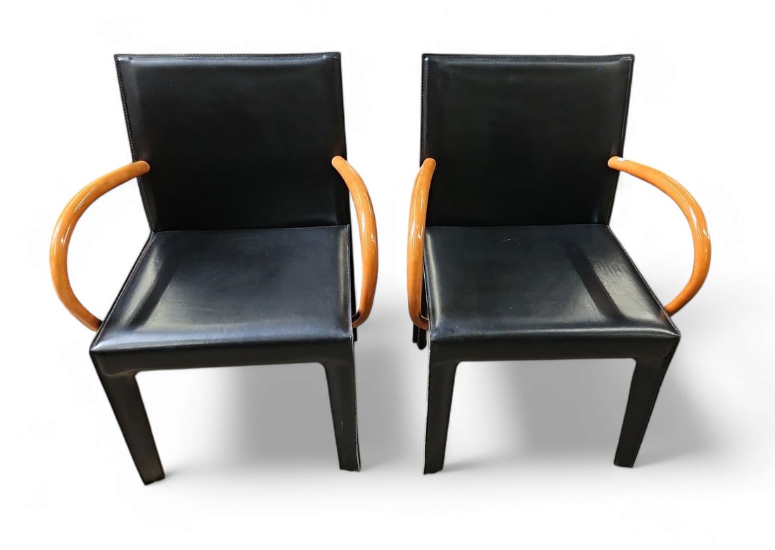 Pr. of Post-Modern Saddle Leather Chairs by Arper.: These handsome dining chairs are completely upholstered in black saddle leather, and have elegant bentwood arms. Both chairs are in excellent condition, with only a few light marks here and here. Each