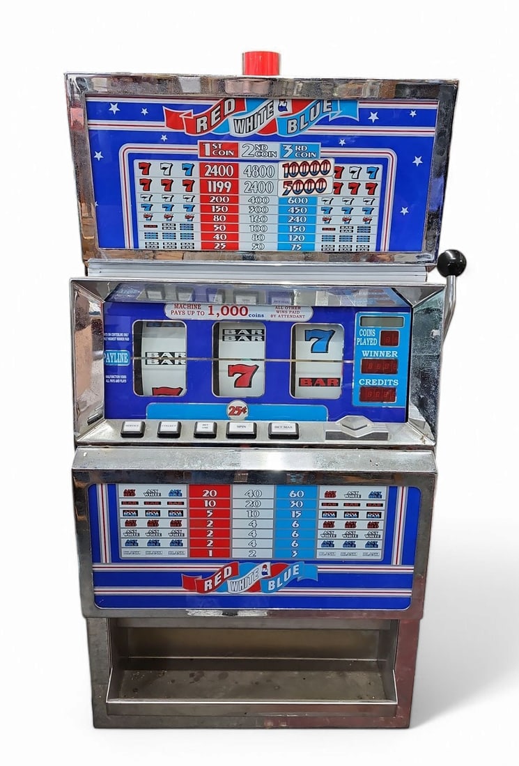 Red White & Blue 25 Cent Slot Machine.: The machine is produced by IGT. It comes with a key. It has light surface rust, but is cosmetically in good overall condition. The machine lights up, but appears to malfunction in general, not operati