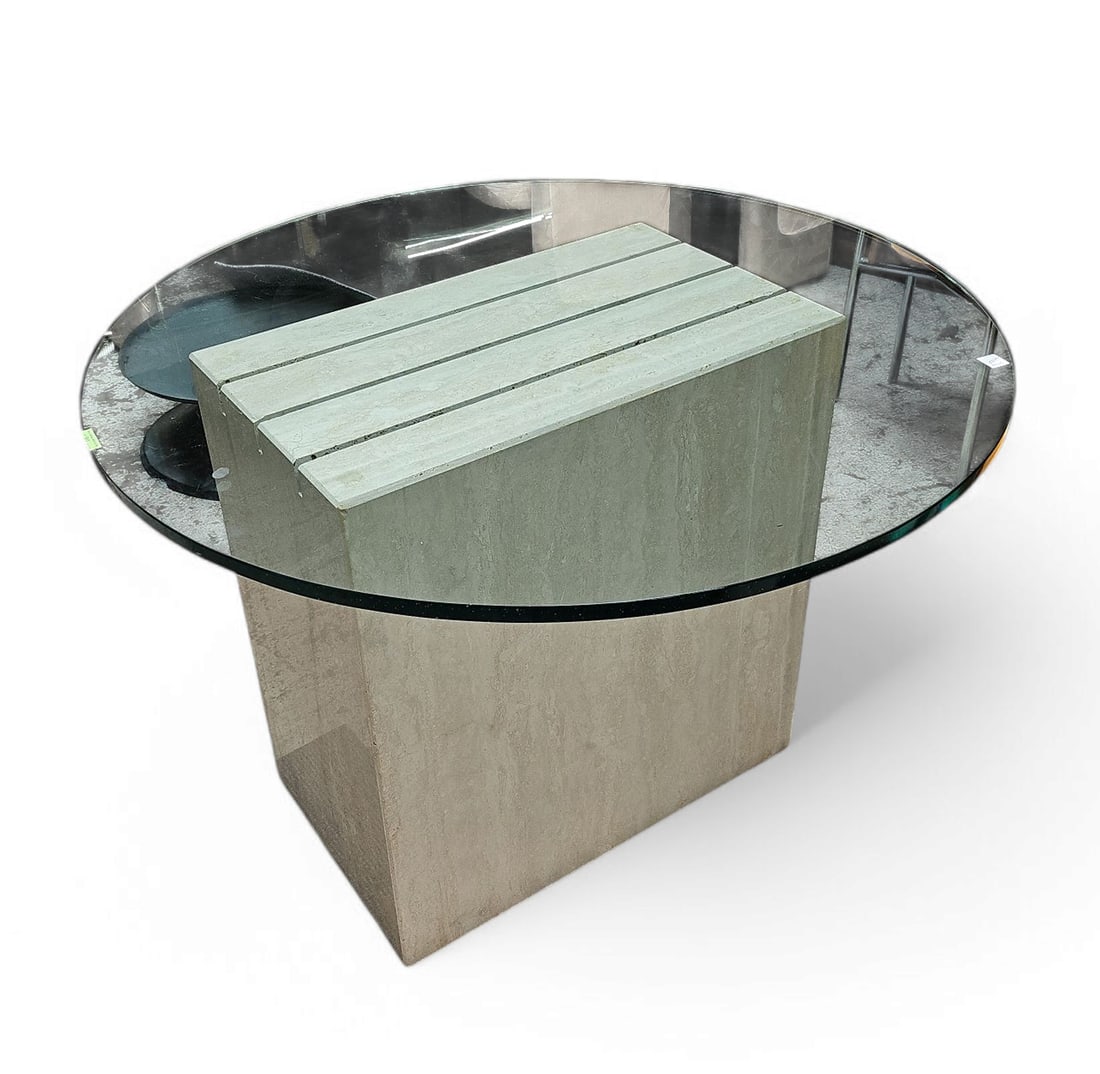 Travertine Table with Glass Top.: The travertine base appears to be in great condition. The circular glass top has a few small chips on the edge, and minor scratches. The base measures 27" wide, 16" deep, and 28" tall. The glass top m