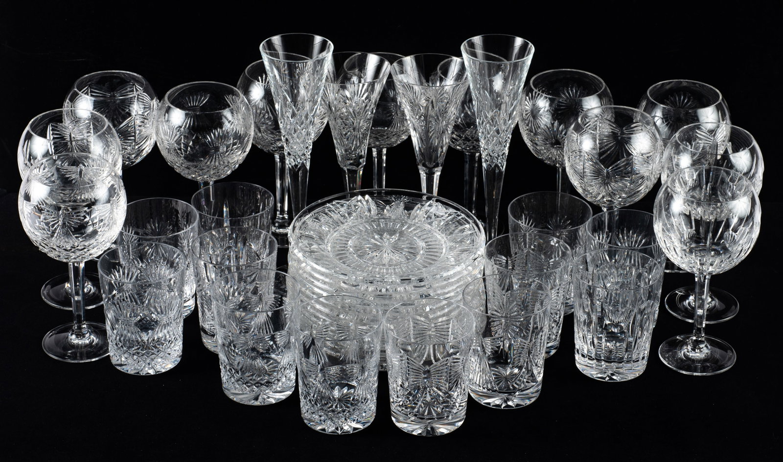 Lot of Waterford Millenium Drinkware & Plates.: The lot contains 40 items in a few different designs. There are 12 tumblers, two 11" champagne flutes, two 9 1/4" champagne flutes, 12 wine glasses, and 12 plates with a diameter of 7 7/8". The items 