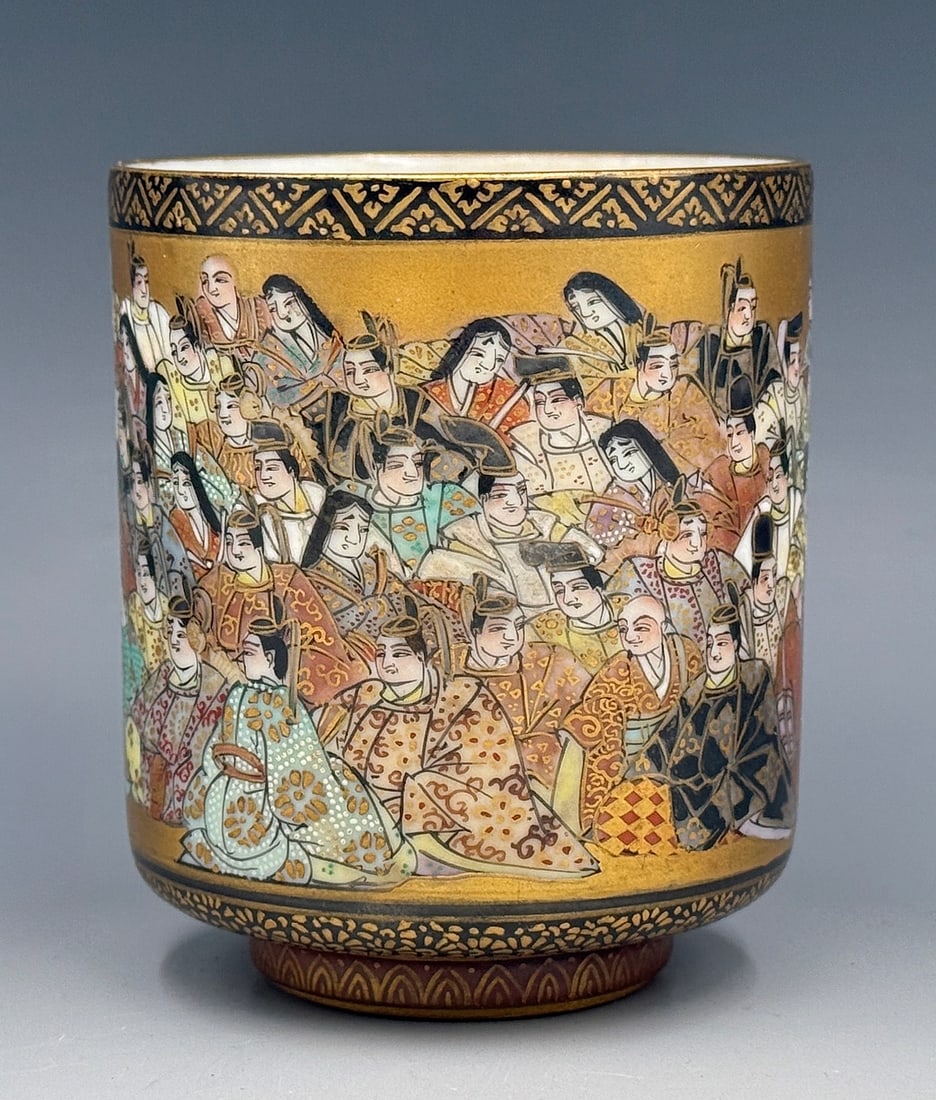 Japanese Meiji Period Kutani Satsuma Cup.: The cup depicts numerous seated figures with gold gilding all around. The interior of the cup has intricate writings all over the inside. The cup is signed on its underside. It is in good overall cond