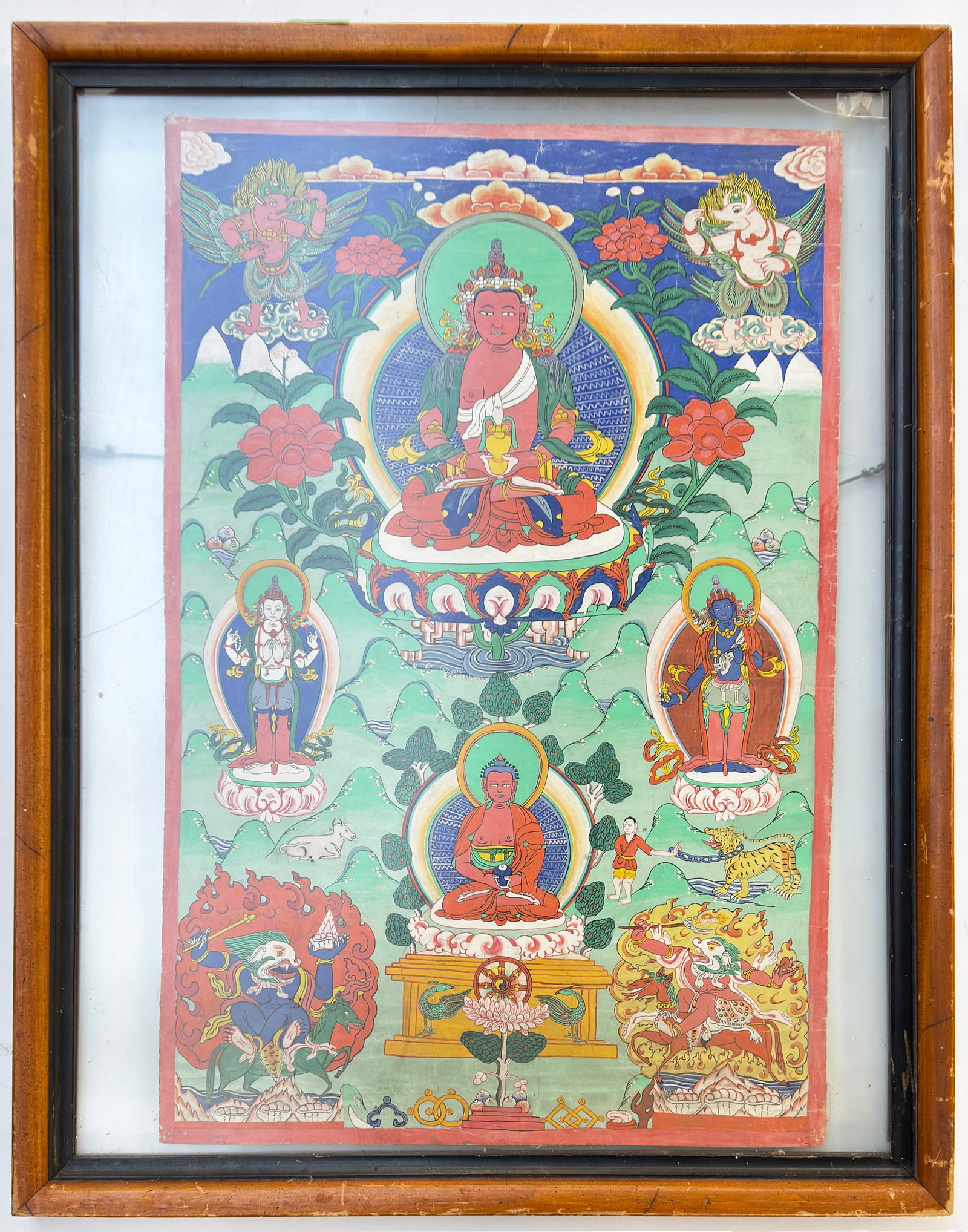 Tibetan Thangka, Framed.: The thangka has some wrinkles and wear. It is in a frame which shows both sides of the piece. The frames' glass is cracked. The thangka itself measures 30" x 19 1/4" The frame, which has a lot of wear
