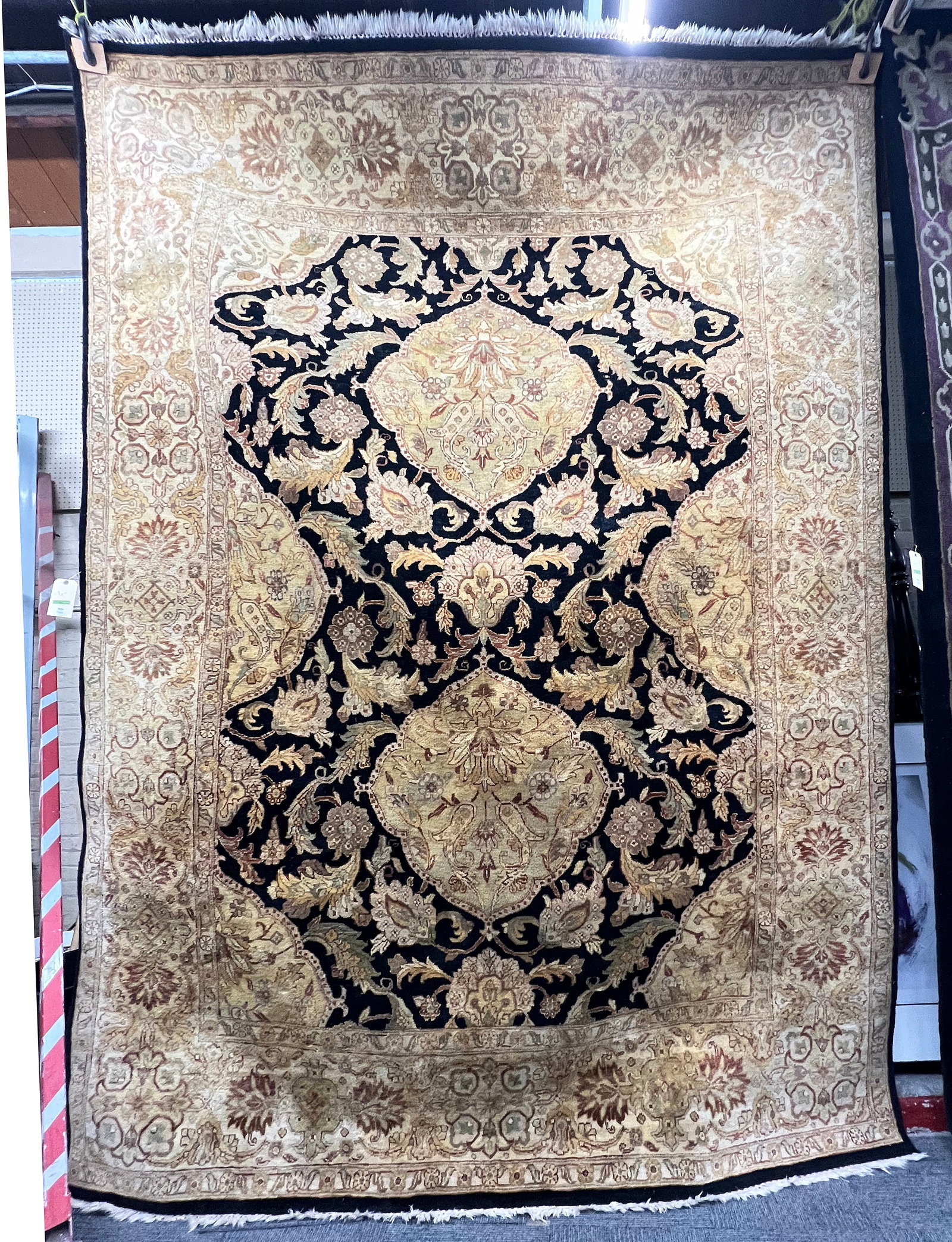 8' 10" x 11' 8" Ornate Gold & Black Handwoven Rug.: The rug looks to be in good overall condition. It looks like it may have some minor discoloration in a few spots. Third-party freight shipping or personal pickup is required. Please see our website fo
