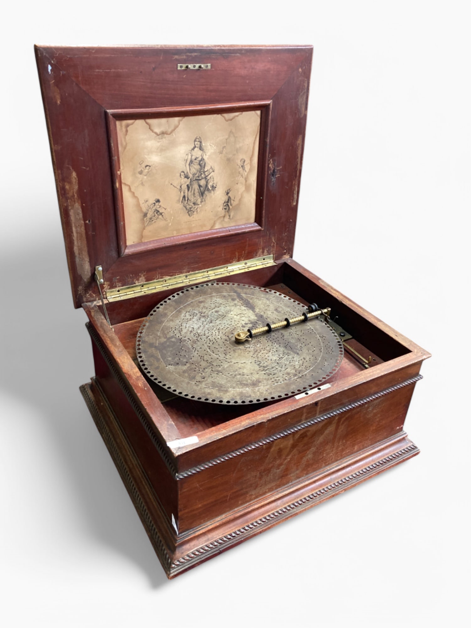 Regina 15 1/2" Metal Disk Music Box.: The music box is in working condition. It comes with one disk. The comb has a few broken teeth (see photos). The case has quite a few scratches and signs of wear, both outside the case and inside as w