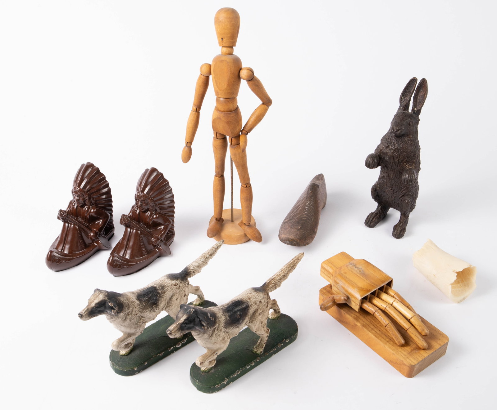 Lot: Bookends, Artist Model, Mechanical Hand, etc.: This lot contains 9 pieces: a pair of cast iron hunting dog bookends, a pair of cast metal Indian chief bookends, an articulated wood artist's model, a winding wood mechanical hand, a wood shoe form, 