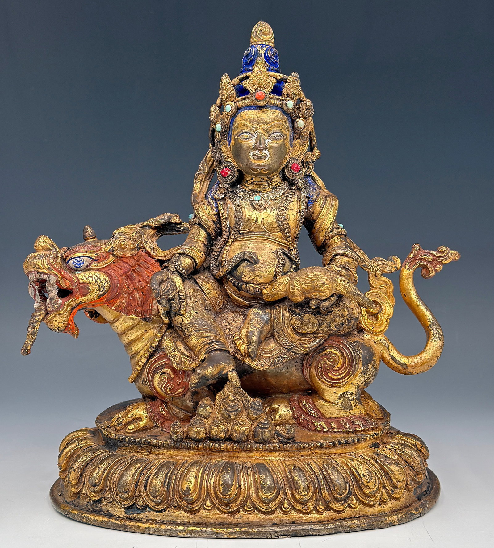 Old Tibetan Gilt Bronze Sculpture of Jambhala.: Jambhala is the deity of wealth. The figure looks to be in good overall condition for its age. It measures 7 3/4" tall, 6 3/4" wide, and 4 5/8" deep. In-house shipping is available. Please see our web