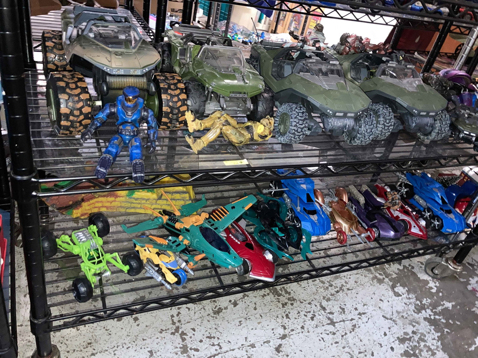 Halo Warthogs & Figures & Hot Wheels Battle Force: The lot contains 22 toy vehicles and figures from the 2000's. Thirteen of the items are from the video game Halo: Warthog vehicles and figures. There is an additional motorcycle, which is broken. The 
