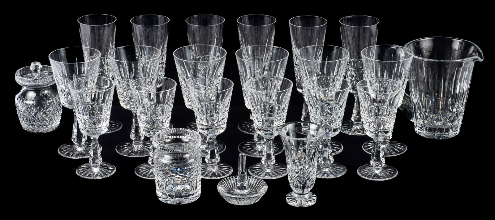Lot of 24 Waterford Crystal Pcs., Mostly Kylemore.: This lot consists of 6 champagne flutes, 6 larger wine goblets, 6 smaller wine goblets, a pitcher, a ring dish, a small footed vase, a condiment jar without lid, and a condiment or honey pot with a li