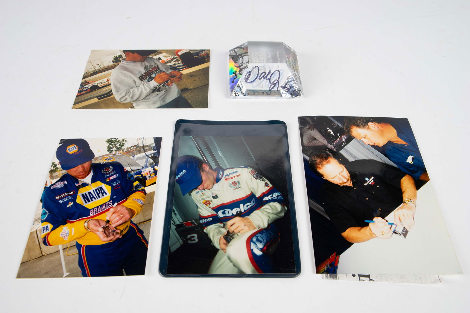 Crystal Paperweight Signed by Earnhardt Sr., Parks: The lot contains a one-of-a-kind Burger King / Coca Cola half pyramid crystal paperweight. It is signed by Dale Earnhardt in blue ink, and is a bit faint. The piece is also signed by Dale Earnhardt Jr