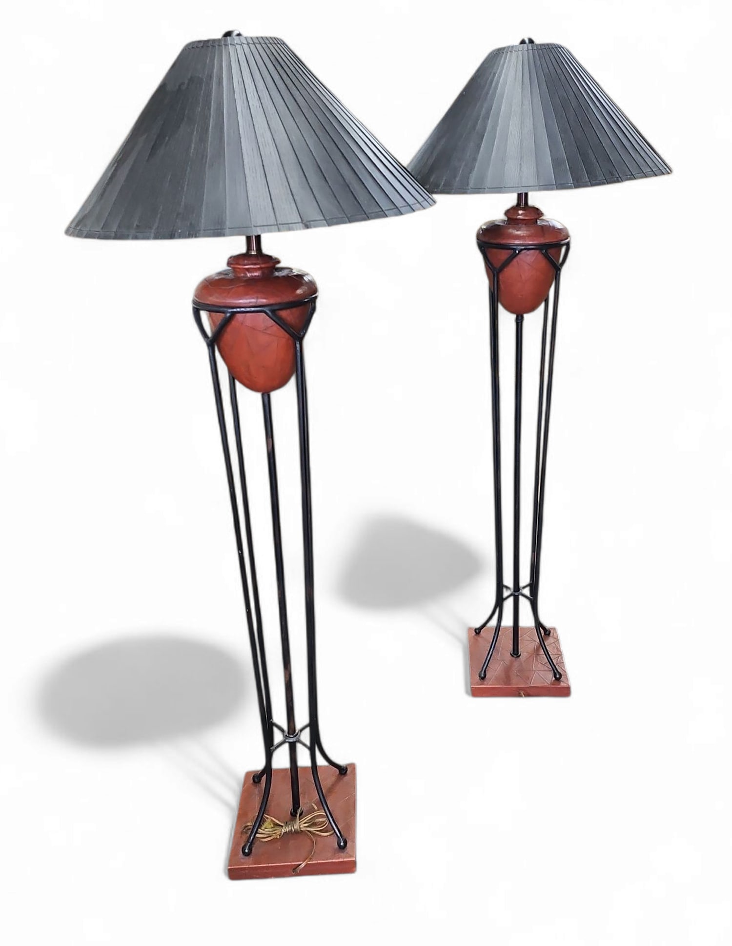 Pair of Signed Frederick Cooper Floor Lamps.: The bases on these lamps are iron, with elements wrapped in leather. Both lamps are in working condition. There are some scratches on the metal, and the thin wood shades have some wear and missing bit