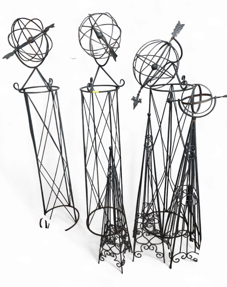 Lot of Six Garden Armillary Sundials and Obelisks.: This lot includes four wrought iron armillary sundials or spheres, as well as two wrought iron obelisks. One of the sundials has a bent arrow. There is light rust and wear. The tallest piece measures